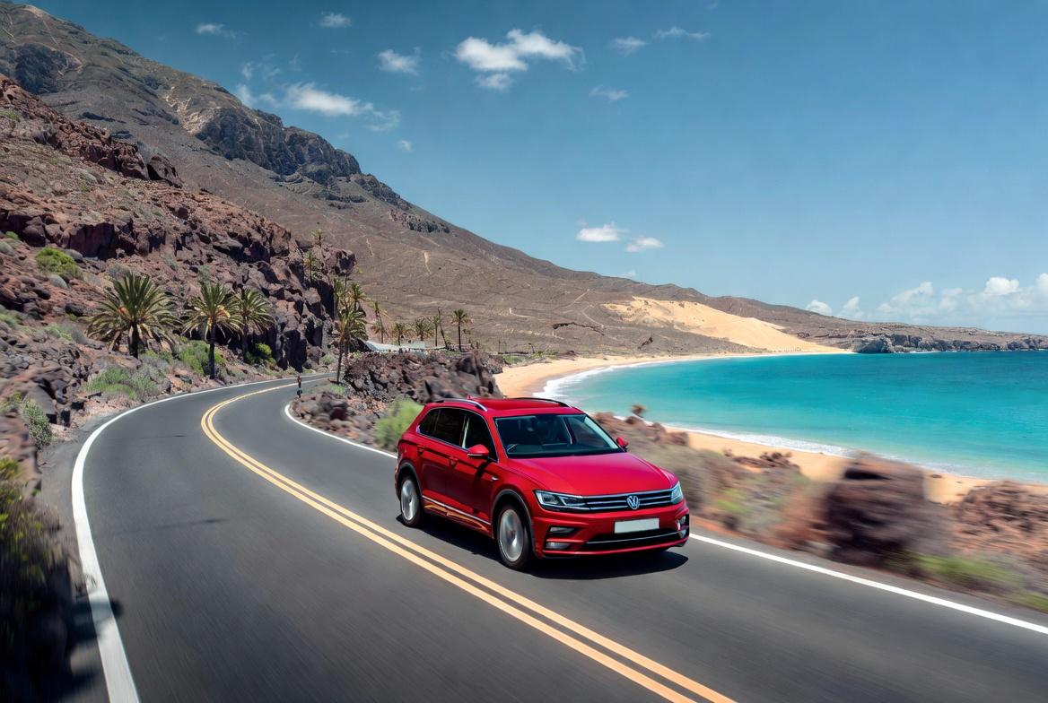 Red car on winding road by the beach in Gran Canaria